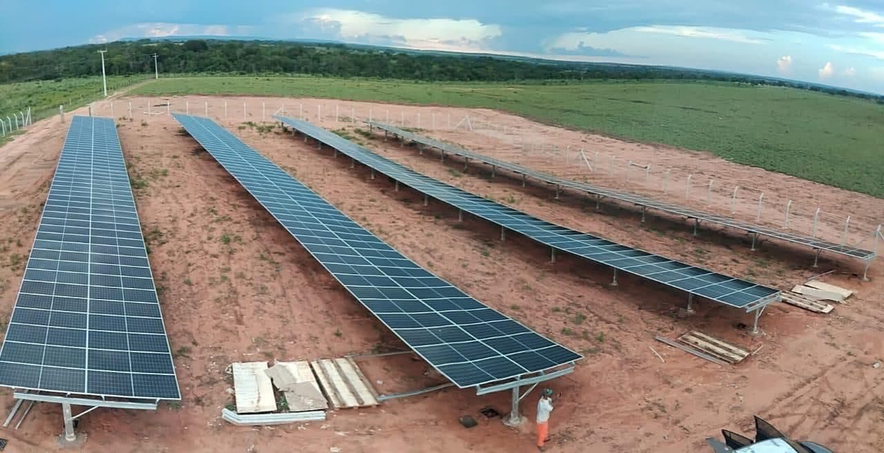 Rows of a ground-mounted solar array being set out on site
