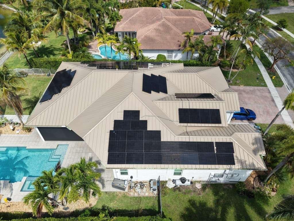 A standing seam metal roof carrying a solar array, seen from the street